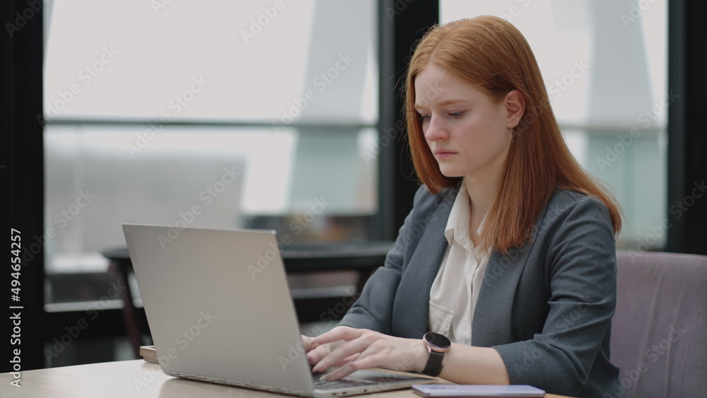 woman is working with laptop in office, typing e-mail for partners and employees, serious and successful businesswoman woman is working with laptop in office, typing e-mail for partners and employees, serious and successful businesswoman