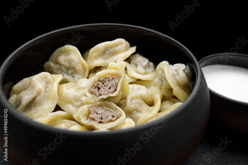 boiled dumplings with pork meat and sour cream