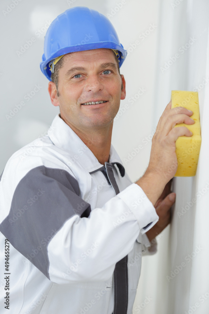 whitewasher man at work before plastering an apartment house whitewasher man at work before plastering an apartment house