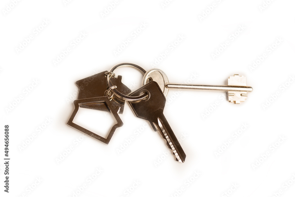 House key with a house shaped keychain, isolated on white background House key with a house shaped keychain, isolated on white background
