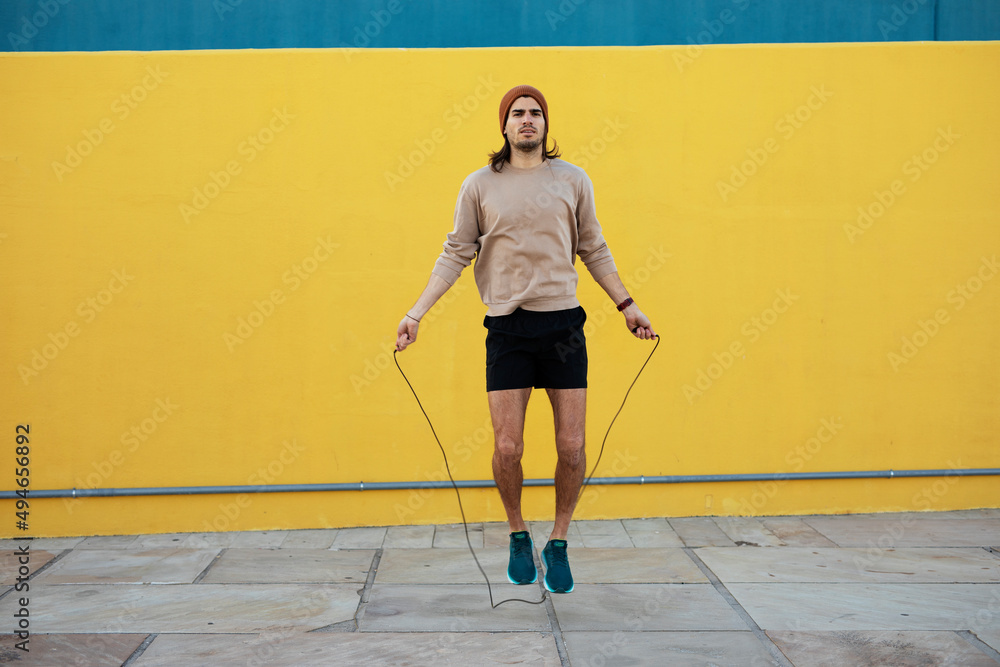 Obraz premium Young muscle man training outside. Fit handsome man doing exercise. Healthy lifestyle