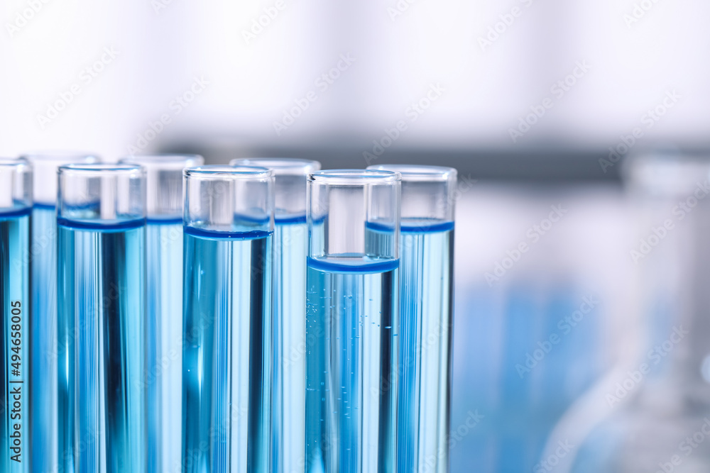 Test tubes with reagents on blurred background, closeup. Laboratory analysis Test tubes with reagents on blurred background, closeup. Laboratory analysis