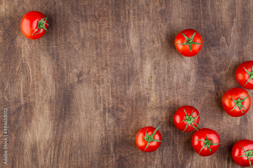 Wooden brown background with tomatoes Wooden brown background with tomatoes