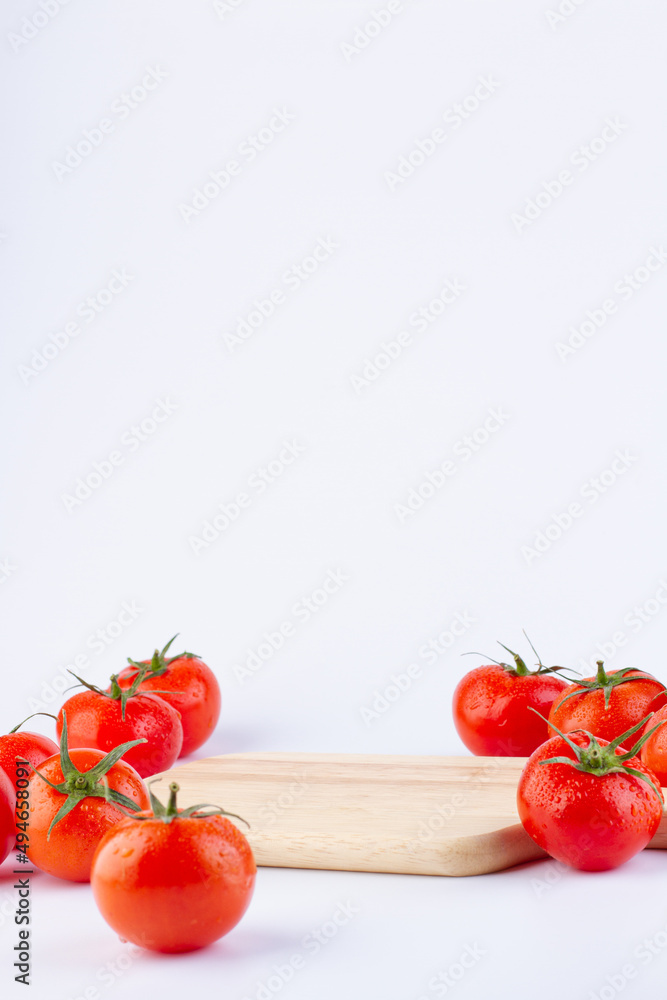 Background with wooden board pedestal and tomatoes Background with wooden board pedestal and tomatoes