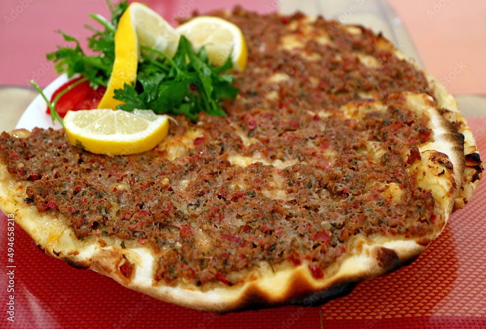 Plate of Lahmacun, a Thin and Crispy Turkish Pizza Topped with Spiced Minced Meat Plate of Lahmacun, a Thin and Crispy Turkish Pizza Topped with Spiced Minced Meat