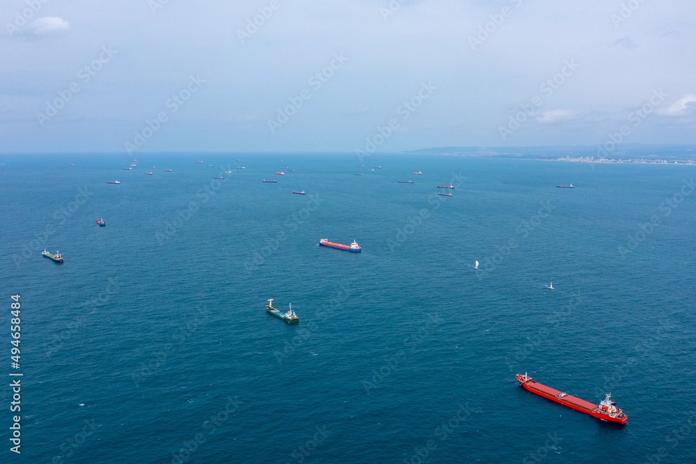 Fifty Cargo and Container ships anchored close to port due to worldwide Maritime congestion crisis, Aerial view.
