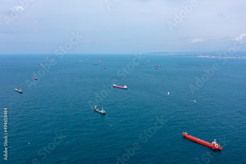 Bilde på lerret Fifty Cargo and Container ships anchored close to port due to worldwide Maritime congestion crisis, Aerial view