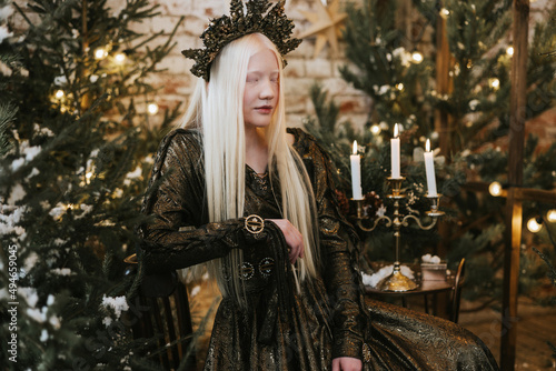 Obraz na plátne young albino woman with blue eyes and long white hair in beautiful green dress a