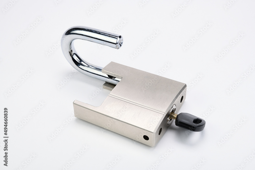A chrome-plated lock with a key illustrates the key to success. A chrome-plated lock with a key illustrates the key to success.