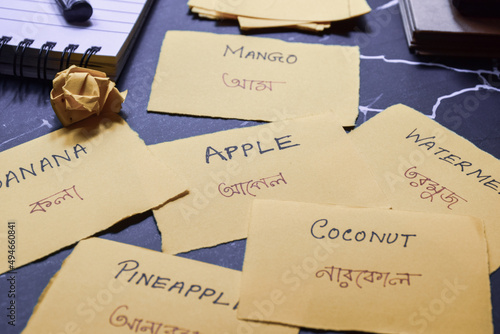 Learning New Language (BENGALI) with Fruits Name Flash Cards. Selective focus.