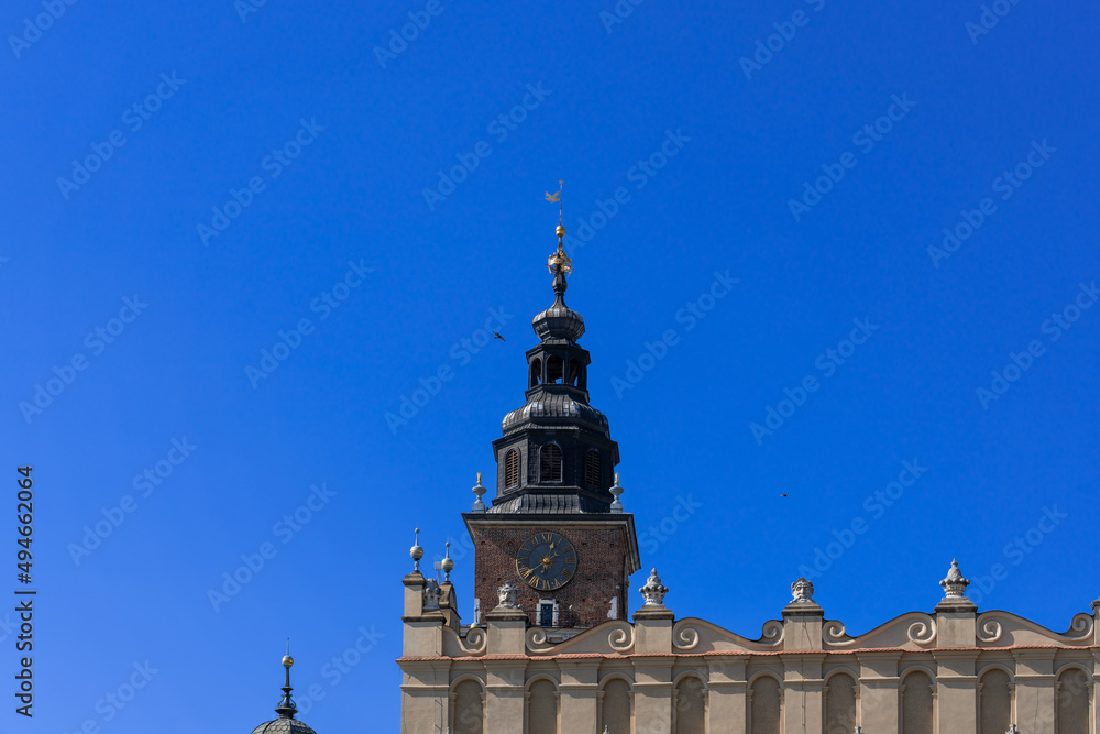 Two doves are flying near the high tower of a medieval castle in the blue sky on a sunny day Two doves are flying near the high tower of a medieval castle in the blue sky on a sunny day