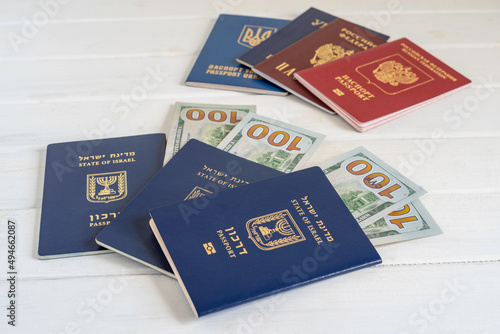Passport of Israel and American dollars on white wooden background. photo