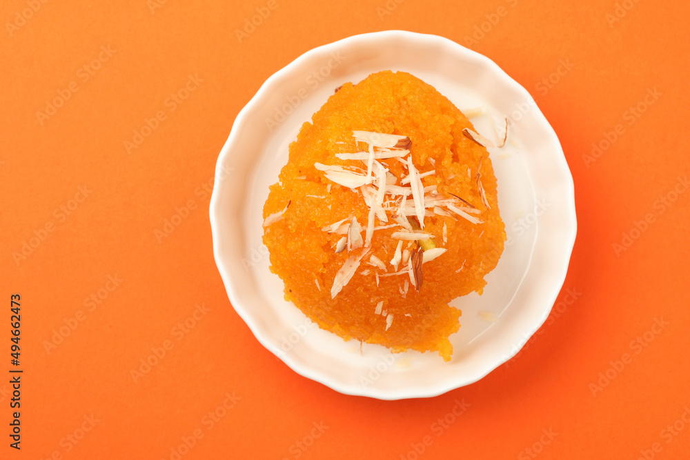 indian gujrati or maharahashtrian or south indian sweet dish SUJI Halwa or sheera or KESARI, famous sweet food in india, also known as halwa, served in white ceramic plate, garnished with dry fruits indian gujrati or maharahashtrian or south indian sweet dish SUJI Halwa or sheera or KESARI, famous sweet food in india, also known as halwa, served in white ceramic plate, garnished with dry fruits