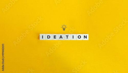 Ideation Word and Bulb Icon. Letter Tiles on Yellow Background. Minimal Aesthetics. photo