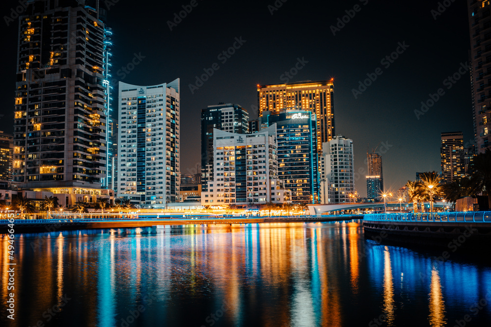 Fantastic nighttime skyline with illuminated skyscrapers. Dubai, UAE