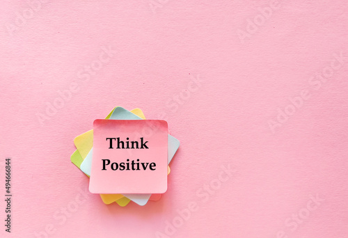 Sticky notes with think  positive message on pink background 