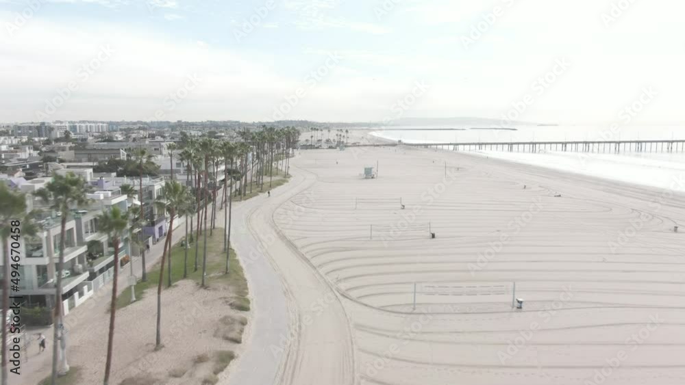 Aerial shot of a beach and a bike lane Aerial shot of a beach and a bike lane