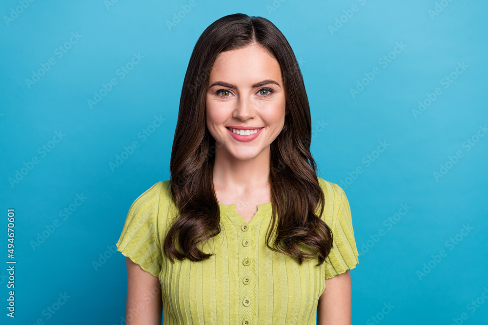 Fototapeta premium Photo of optimistic millennial brunette lady wear green t-shirt isolated on blue color background