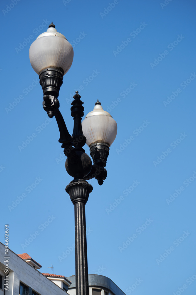 Street lamp in the foreground with blue sky