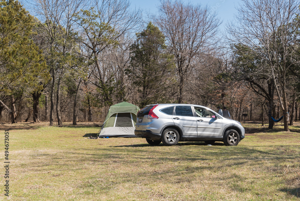 Side view SUV and large family tent at camping site in national park of Oklahoma, America