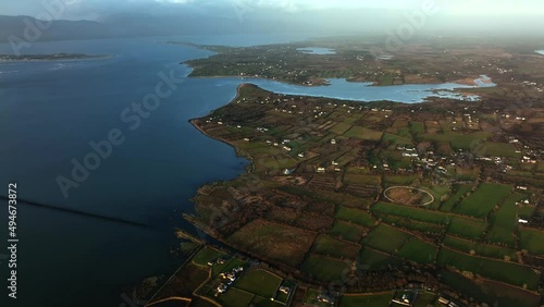 Glenbeigh, Kerry, Ireland, March 2022. Drone slowly tracks northwest above Castlemaine Harbour facing east towards Kilnabrack Lower with Rossbehy Creek and the Slieve Mish Mountains in the distance. photo