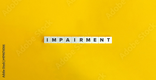 Impairment in Corporate Finance and Accounting. Letter Tiles on Yellow Background. Minimal Aesthetics.