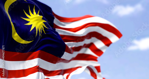 Detail of the national flag of Malaysia waving in the wind on a clear day. photo