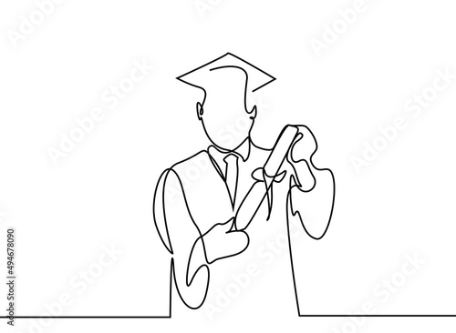 a teenager is graduating and happily holding the diploma in his graduation gown