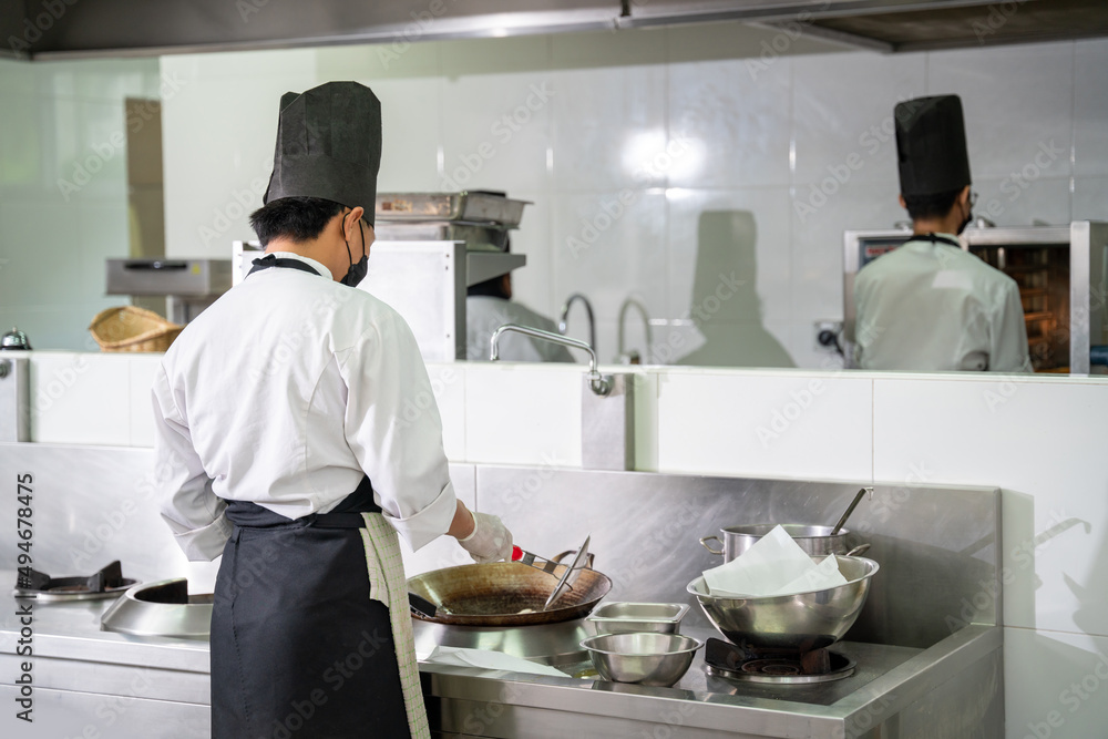 Two chefs prepare meals in the restaurant's kitchen. Modern kitchen. Two chefs prepare meals in the restaurant's kitchen. Modern kitchen.