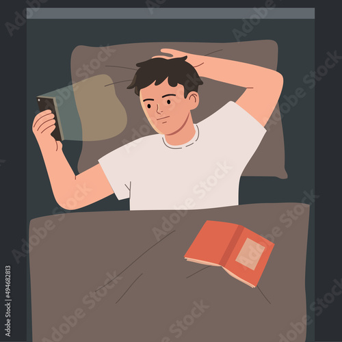 Young man lying in bed and looking at smartphone at night.  Hand drawn vector cartoon style illustration