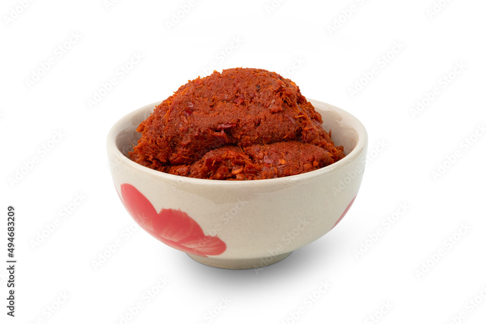 Thai red curry paste in a bowl isolated on white background with clipping path