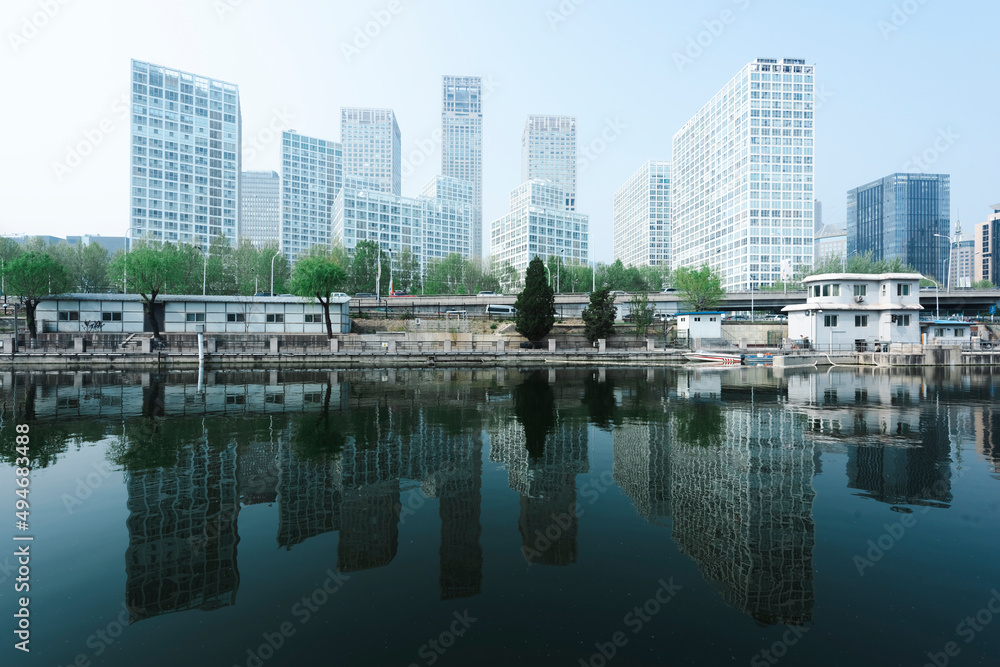 Fototapeta premium City buildings are reflected on the river