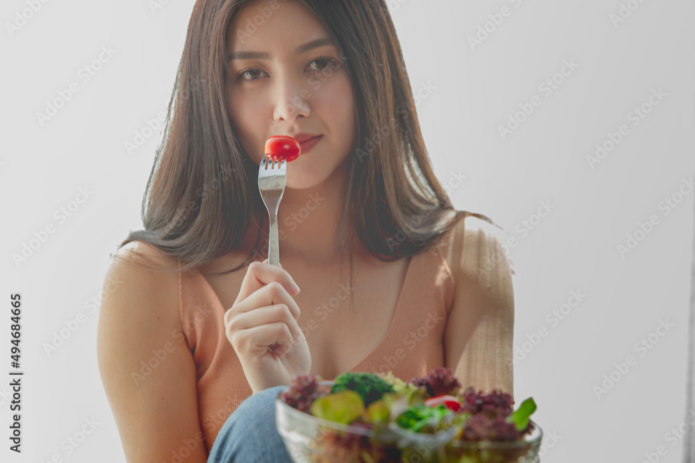 asian woman with healthy food, Beautiful girl eating a salad in house, health care eat vegetables and useful foods lifestyles concept. asian woman with healthy food, Beautiful girl eating a salad in house, health care eat vegetables and useful foods lifestyles concept.