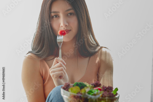 asian woman with healthy food,  Beautiful girl eating a salad in house, health care eat vegetables and useful foods lifestyles concept.