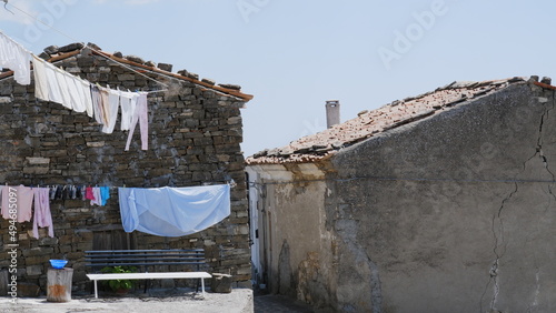 Clothes drying on a rack after laundry in the narrow street