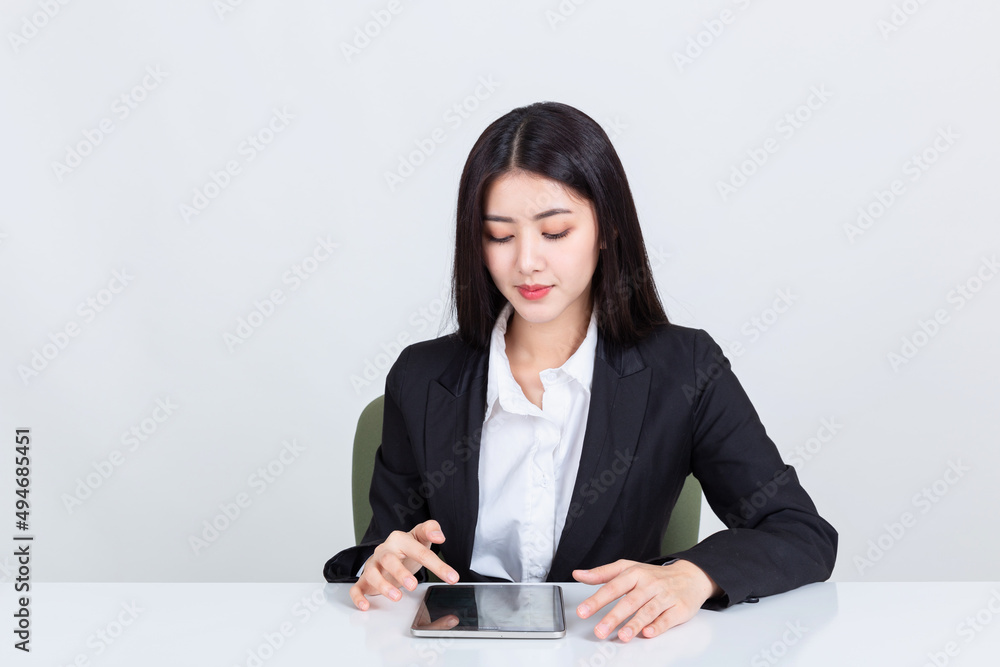 Asian business woman sit at desk in office using tablet Asian business woman sit at desk in office using tablet