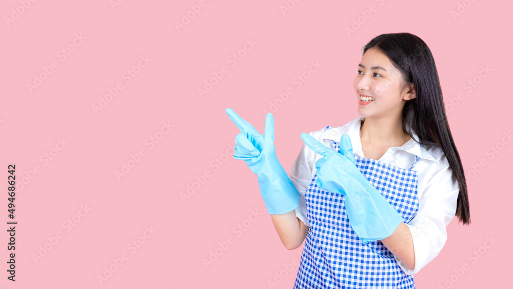 Portrait asian beautiful woman wearing apron and rubber gloves for cleaning , Housekeeper standing with products and equipment cleaner. Portrait asian beautiful woman wearing apron and rubber gloves for cleaning , Housekeeper standing with products and equipment cleaner.