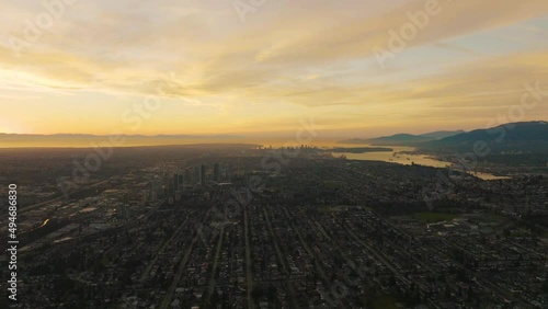 Golden sunset over sprawling west coast metropolis, Vancouver, B.C.; aerial photo