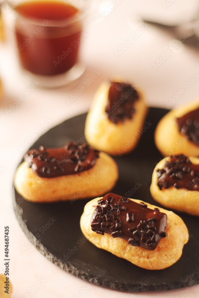 Traditional French dessert - eclairs with a cup of coffee	