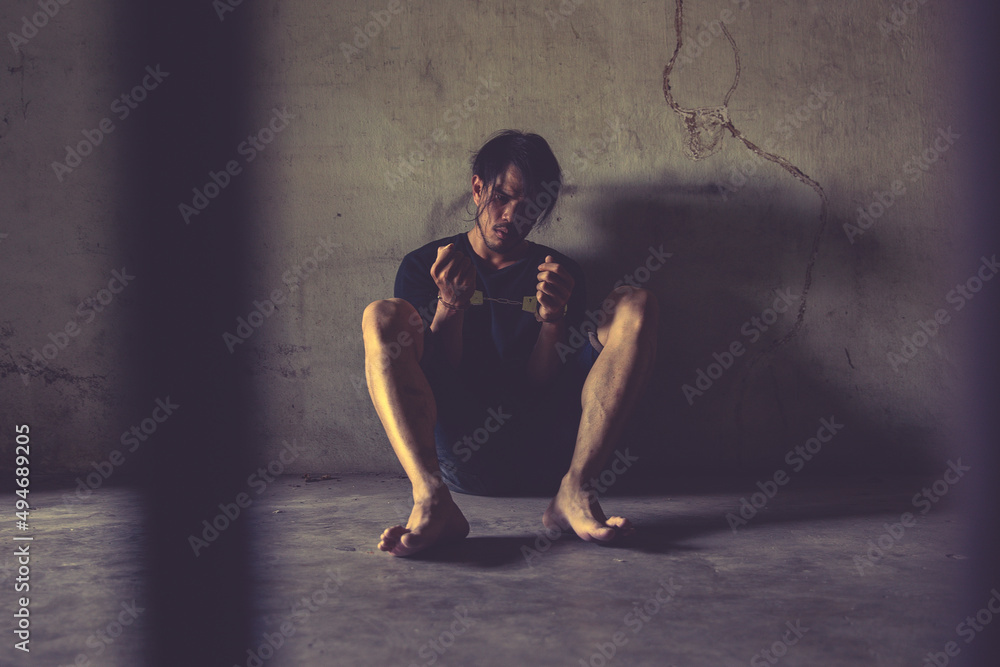 Fototapeta premium criminal tying hands with handcuffs.