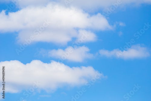blue sky with white fluffy cumulus clouds