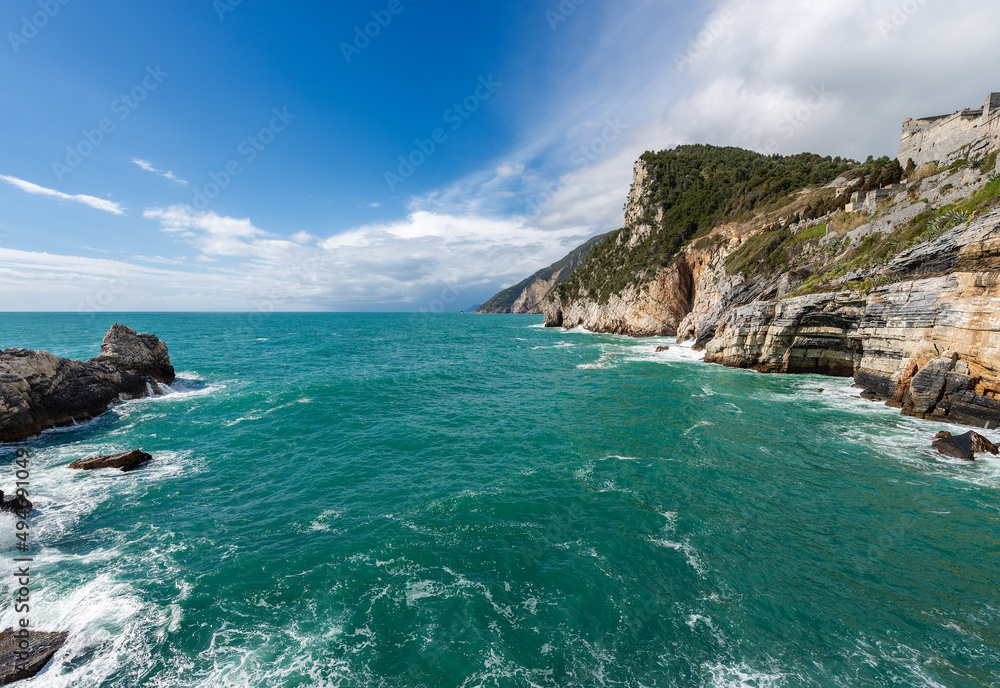 Beautiful bay and rocky cliffs in front of the famous Porto Venere or Portovenere town, Mediterranean and Ligurian Sea, coast fo Cinque Terre National Park. La Spezia province, Liguria, Italy, Europe.