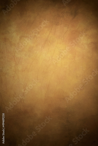 Warm colors painted fabric photography studio background with shades of yellow and brown with hints of pink.