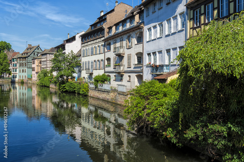 Timbered Houses reflecting in the ILL canal along the riverbank of the Petite France, Strasbourg, Alsace, Bas-Rhin Department, France