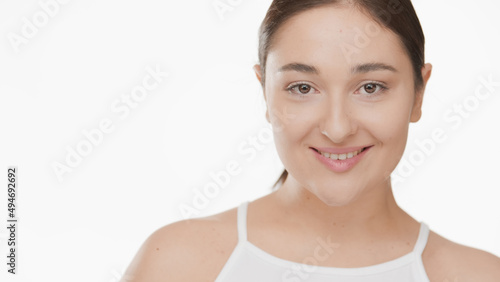 Close-up beauty portrait of pretty brunette Caucasian woman white top on white background   Droopy eyes removal concept © pavel_dp
