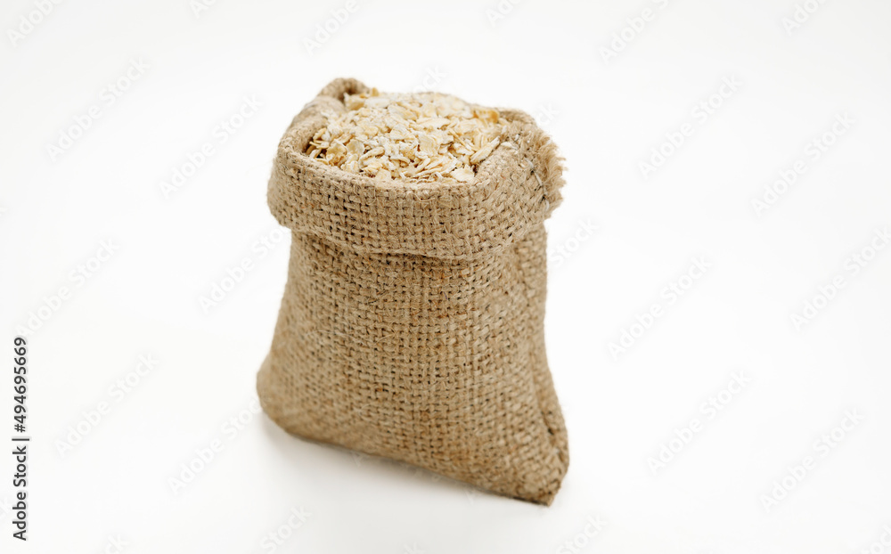 Оatmeal in bowls and bags isolated on a white background. High quality photo Оatmeal in bowls and bags isolated on a white background. High quality photo