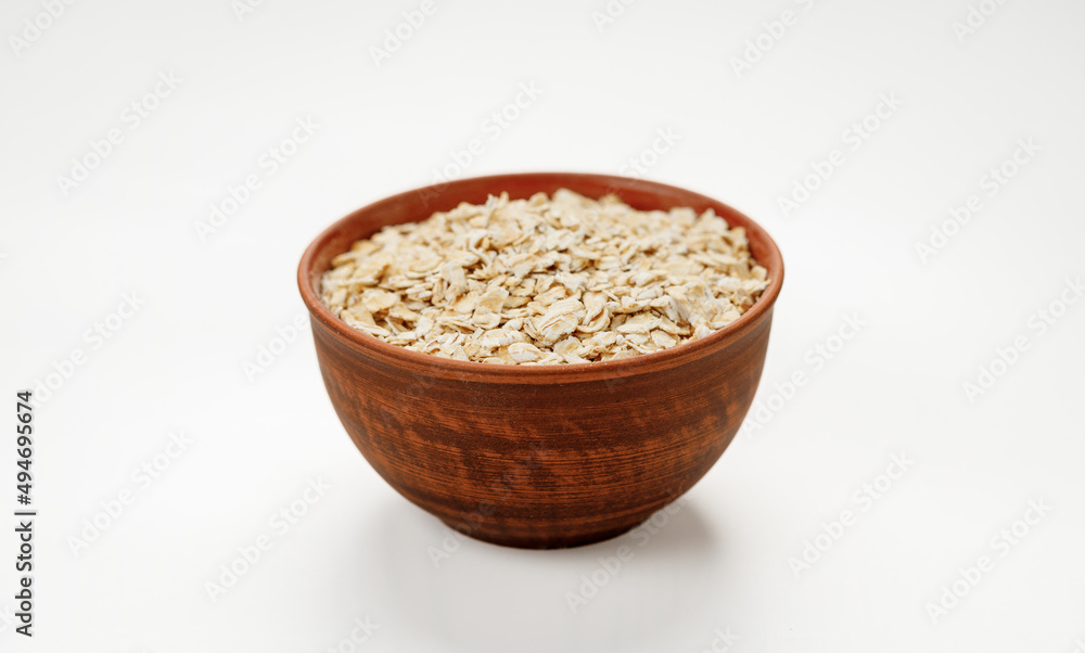 Оatmeal in bowls and bags isolated on a white background. High quality photo Оatmeal in bowls and bags isolated on a white background. High quality photo