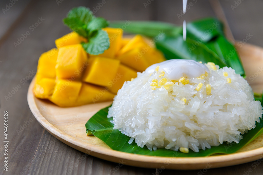 motion of coconut milk on Coconut Flavored Sticky Rice with Ripe Mango