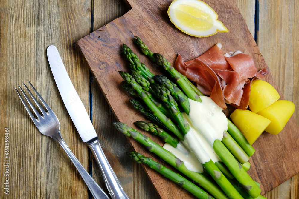 Green asparagus with Parma ham with sauce hollandaise Green asparagus with Parma ham with sauce hollandaise