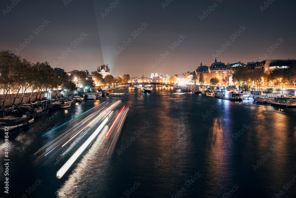 night view of the city of paris on the seine